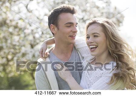 Stock Photo - Couple hugging outdoors. Fotosearch