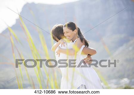 Stock Photograph - Couple hugging outdoors. Fotosearch