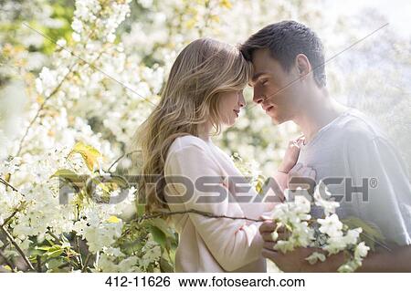Couple hugging outdoors View Large Photo Image Stock Photograph - Couple hugging outdoors. Fotosearch