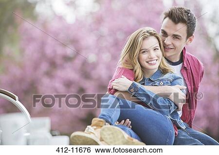Couple hugging outdoors View Large Photo Image Stock Photograph - Couple hugging outdoors. Fotosearch