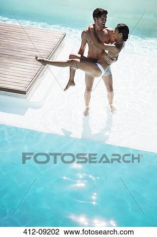 Couple relaxing in swimming pool View Large Photo Image Stock Image - Couple relaxing in swimming pool. Fotosearch