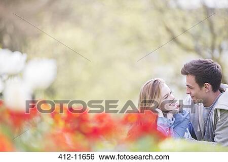 Stock Photograph - Couple relaxing together outdoors. Fotosearch