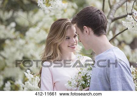 Couple smiling outdoors View Large Photo Image Stock Image - Couple smiling outdoors. Fotosearch