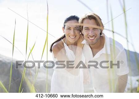 Couple smiling together outdoors View Large Photo Image Stock Image - Couple smiling together outdoors. Fotosearch