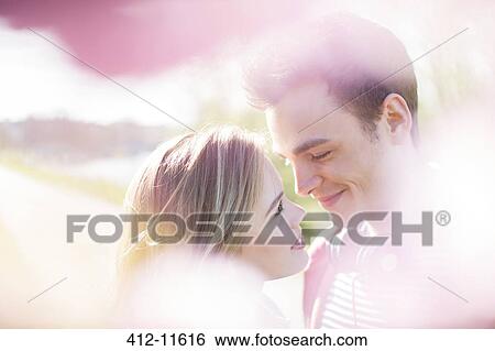 Couple smiling together outdoors View Large Photo Image Stock Photograph - Couple smiling together outdoors. Fotosearch