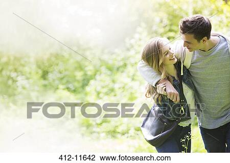 Couple walking together outdoors View Large Photo Image Stock Image - Couple walking together outdoors. Fotosearch
