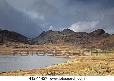 Craggy hills beyond lake View Large Photo Image Stock Photo - Craggy hills beyond lake. Fotosearch