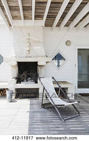 Deck chair and fireplace on patio View Large Photo Image Stock Photo - Deck chair and fireplace on patio. Fotosearch