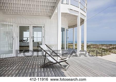 Deck chair on deck overlooking beach View Large Photo Image Stock Photograph - Deck chair on deck overlooking beach. Fotosearch