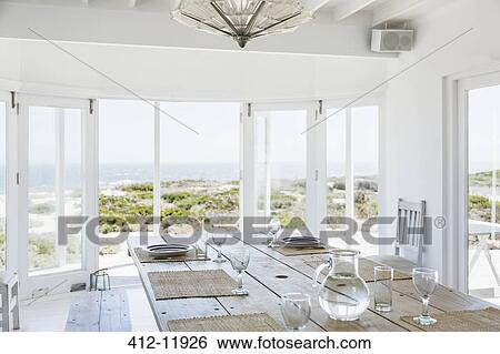 Stock Photograph - Dining room overlooking ocean. Fotosearch