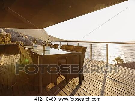 Dining table on luxury patio overlooking ocean View Large Photo Image Stock Photo - Dining table on luxury patio overlooking ocean. Fotosearch