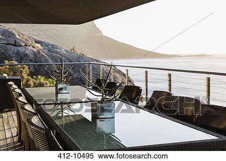 Dining table on luxury patio overlooking ocean View Large Photo Image Stock Photography - Dining table on luxury patio overlooking ocean. Fotosearch