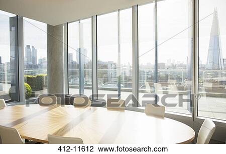 Stock Image - Empty conference room overlooking city. Fotosearch