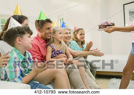 Stock Image - Family celebrating girls birthday. Fotosearch