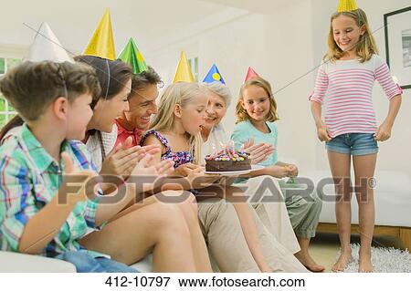 Stock Photo - Family celebrating girls birthday. Fotosearch