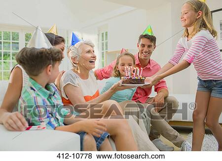 Family celebrating older womans birthday View Large Photo Image Stock Photo - Family celebrating older womans birthday. Fotosearch