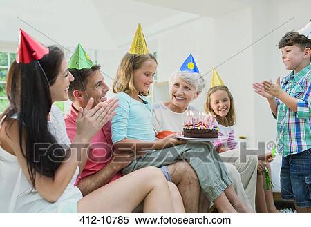 Family celebrating older womans birthday View Large Photo Image Stock Photography - Family celebrating older womans birthday. Fotosearch
