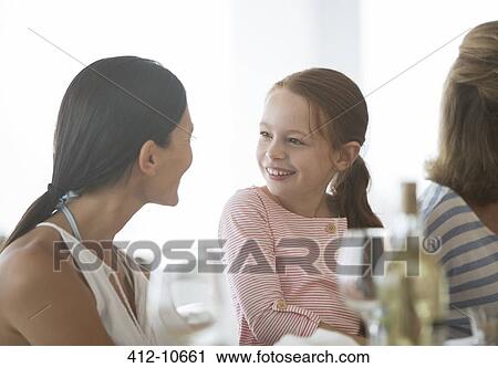 Family eating together at table View Large Photo Image Stock Image - Family eating together at table. Fotosearch