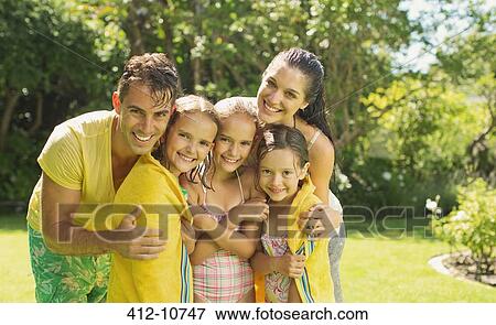 Family relaxing together in backyard View Large Photo Image Stock Photo - Family relaxing together in backyard. Fotosearch