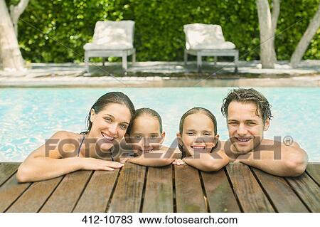 Family relaxing together in pool View Large Photo Image Stock Image - Family relaxing together in pool. Fotosearch