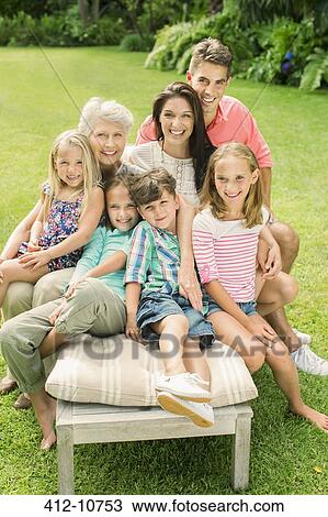 Family sitting together in backyard View Large Photo Image Stock Image - Family sitting together in backyard. Fotosearch