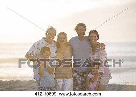 Family smiling together on beach View Large Photo Image Stock Photo - Family smiling together on beach. Fotosearch