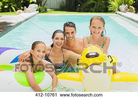 Family swimming in pool together View Large Photo Image Stock Image - Family swimming in pool together. Fotosearch