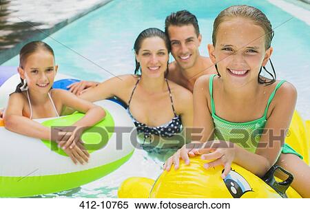Family swimming together in pool View Large Photo Image Stock Photography - Family swimming together in pool. Fotosearch