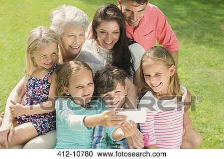 Family taking picture together with cell phone View Large Photo Image Stock Image - Family taking picture together with cell phone. Fotosearch
