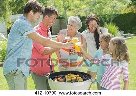 Family toasting each other at barbecue View Large Photo Image Stock Image - Family toasting each other at barbecue. Fotosearch