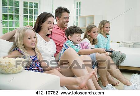Family watching television together View Large Photo Image Stock Image - Family watching television together. Fotosearch