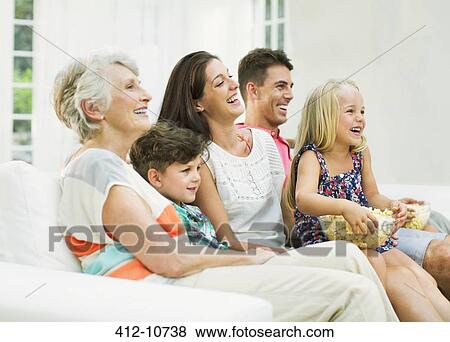 Stock Photo - Family watching television together. Fotosearch