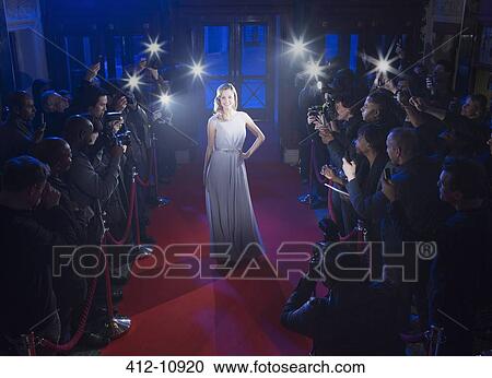 Fans and paparazzi surrounding female celebrity posing on red carpet View Large Photo Image Stock Image - Fans and paparazzi surrounding female celebrity posing on red carpet. Fotosearch