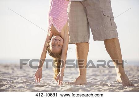 Father and daughter playing on beach View Large Photo Image Stock Image - Father and daughter playing on beach. Fotosearch