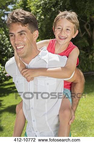 Father and son playing in backyard View Large Photo Image Stock Image - Father and son playing in backyard. Fotosearch