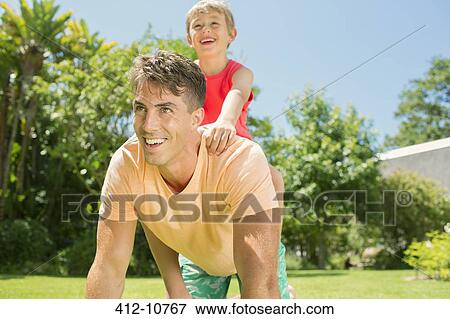 Stock Photo - Father and son playing in backyard. Fotosearch