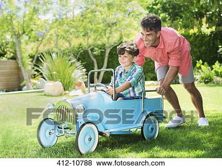Father and son playing in backyard View Large Photo Image Stock Photo - Father and son playing in backyard. Fotosearch