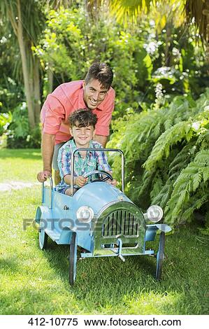 Father and son playing in backyard View Large Photo Image Stock Photography - Father and son playing in backyard. Fotosearch