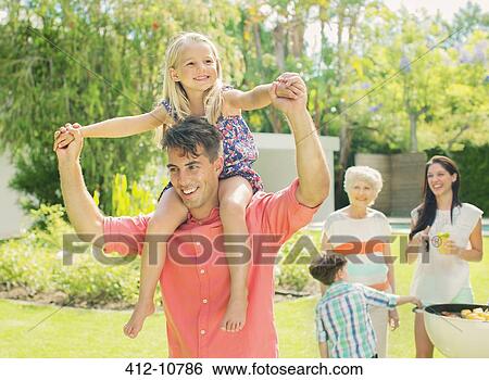 Stock Photograph - Father carrying daughter on shoulders. Fotosearch