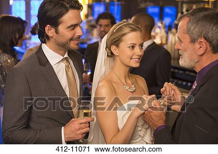Father holding bride's hands at wedding reception View Large Photo Image Stock Image - Father holding bride's hands at wedding reception. Fotosearch