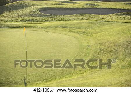 Flag in hole on golf course View Large Photo Image Stock Photo - Flag in hole on golf course. Fotosearch