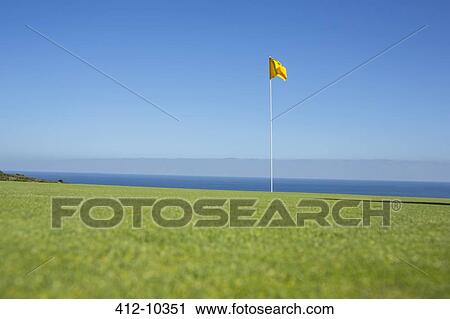 Flag on golf course overlooking ocean View Large Photo Image Stock Image - Flag on golf course overlooking ocean. Fotosearch