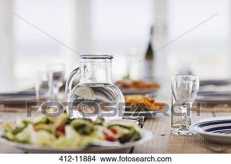 Food and water on set table View Large Photo Image Picture - Food and water on set table. Fotosearch