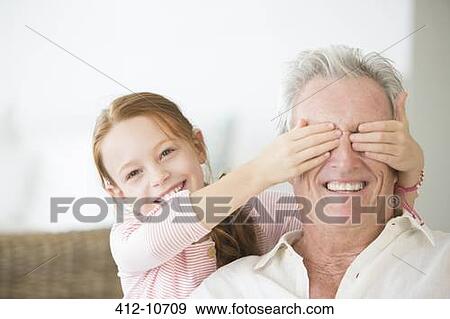 Girl covering grandfathers eyes View Large Photo Image Stock Photo - Girl covering grandfathers eyes. Fotosearch