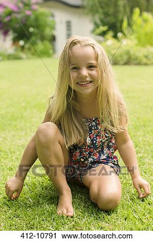 Girl smiling in backyard View Large Photo Image Stock Image - Girl smiling in backyard. Fotosearch