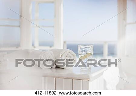 Glass of water and towels on table View Large Photo Image Stock Image - Glass of water and towels on table. Fotosearch