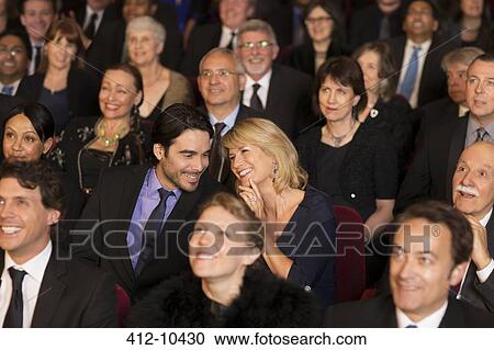 Stock Image - Happy couple clapping in theater audience. Fotosearch