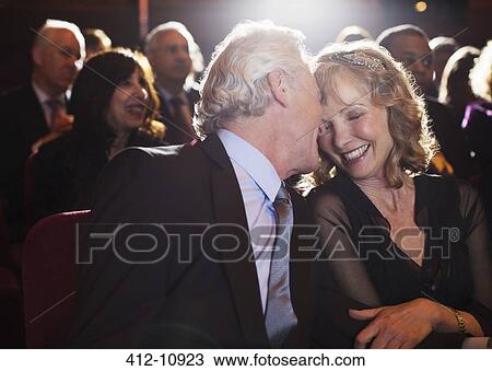 Happy senior couple hugging in theater audience View Large Photo Image Stock Image - Happy senior couple hugging in theater audience. Fotosearch