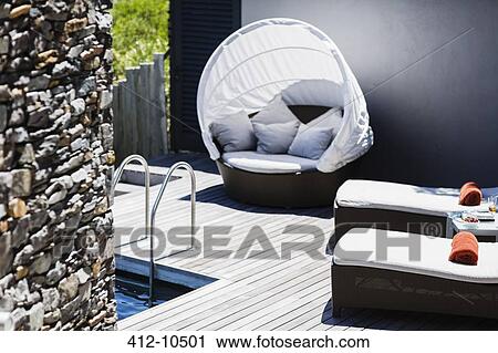 Lounge chairs at poolside View Large Photo Image Stock Image - Lounge chairs at poolside. Fotosearch