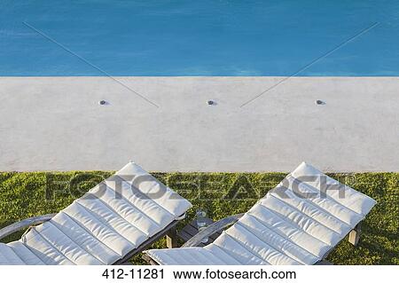 Lounge chairs at poolside View Large Photo Image Stock Image - Lounge chairs at poolside. Fotosearch